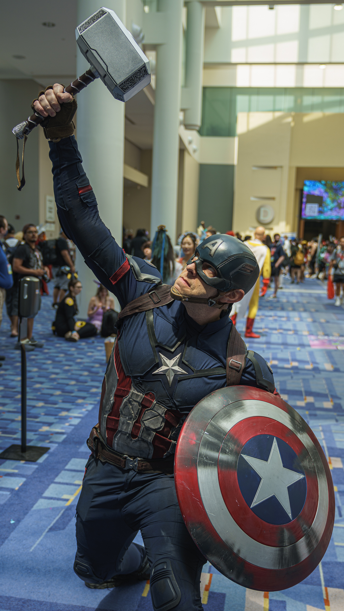 Captain America raises Thor's Hammer above his head at Otakon 2023